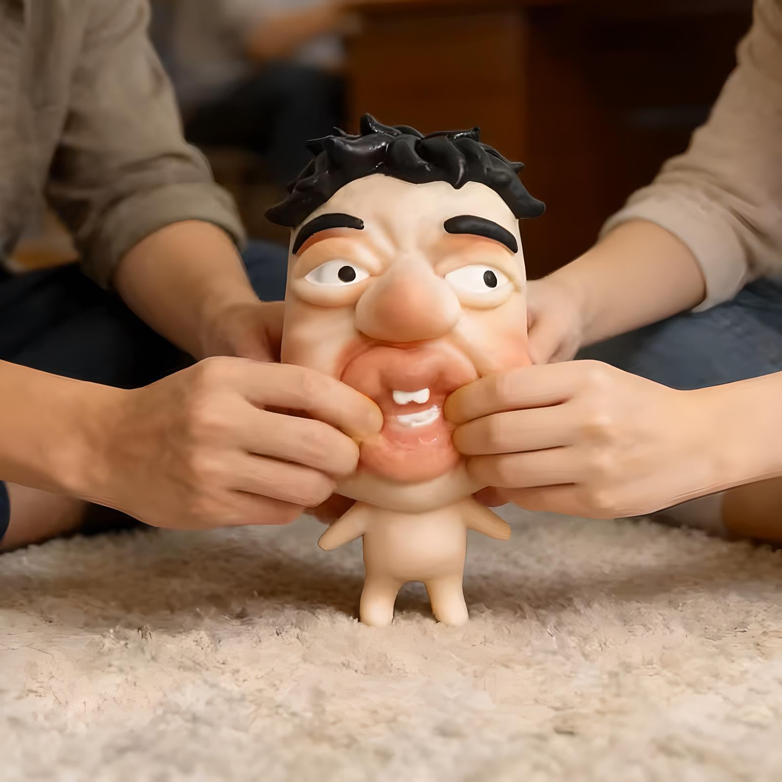 Hands squeezing a soft squishy stress relief toy with a funny facial expression, demonstrating stress relief and sensory play.